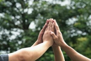 Hands joined with nature background - ESG