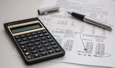 Calculator and pen resting on HRLocker document