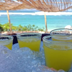 cocktail on beach for staff holiday planning blog post