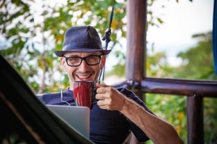 Man drinking coffee while working from home