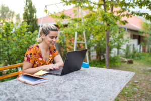 Happy woman remote working outside