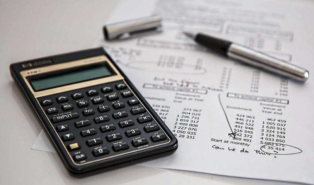 Calculator and pen resting on HRLocker document