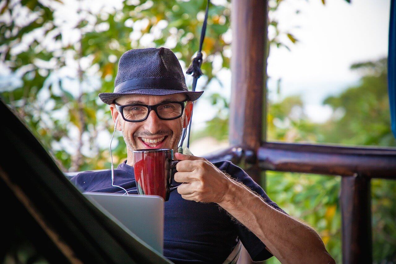 Man drinking coffee while working from home